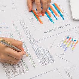 Business woman hand  with Financial charts  and laptop on the table